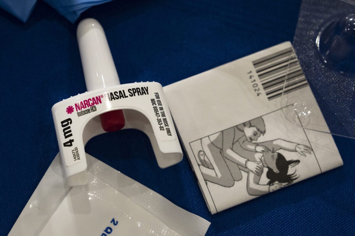 naloxone narcan nasal spray atomizer with instructions on display