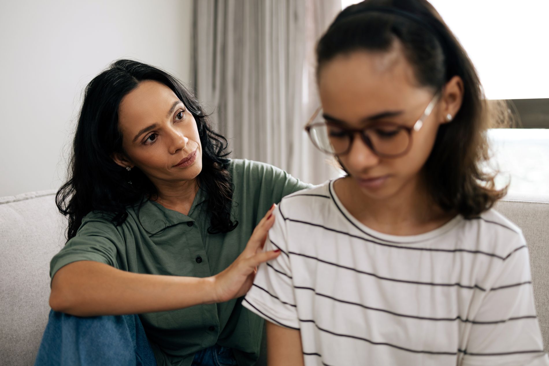 A woman comforting her daughter, representing coping skills for tweens