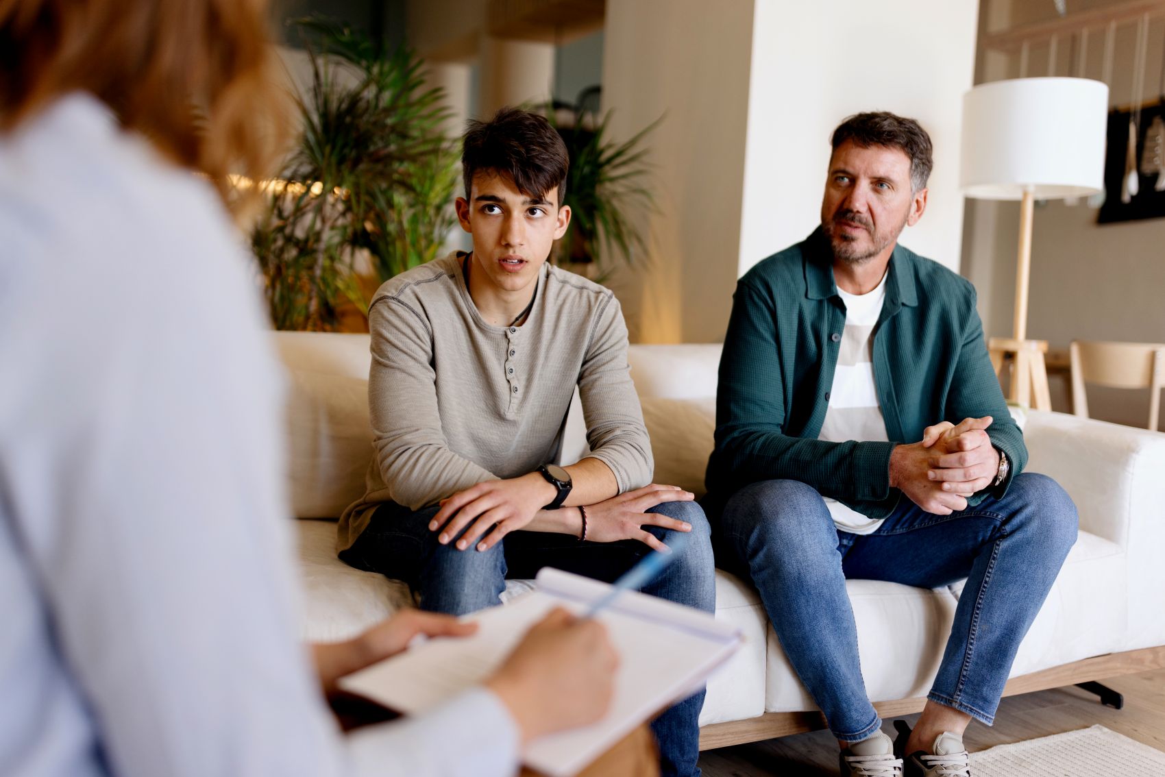 Parents talk to their teenage son, representing questions to ask your teen about drinking