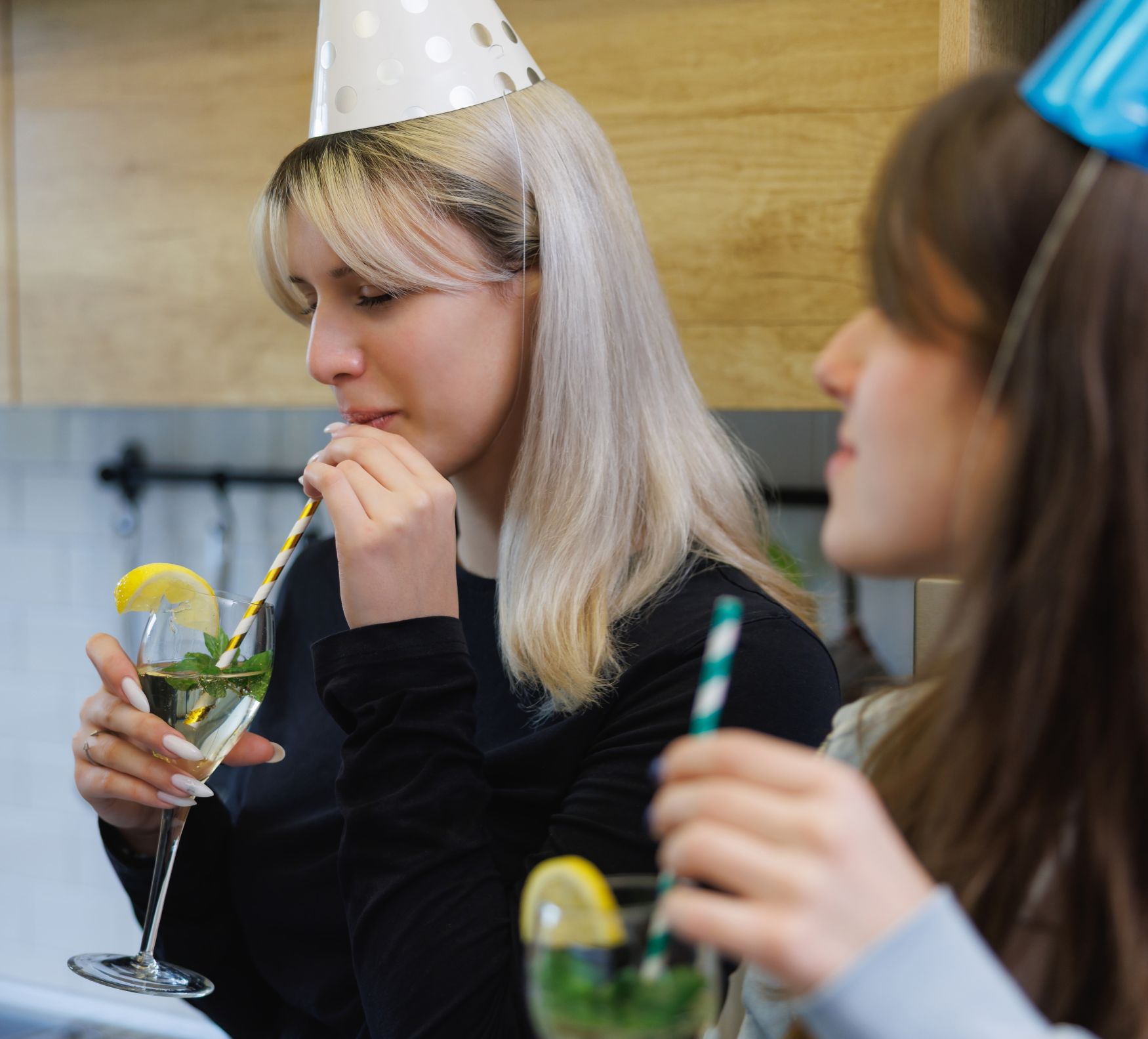 A girl drinks a cocktail at a party. Can teens drink non-alcoholic beer or mocktails?